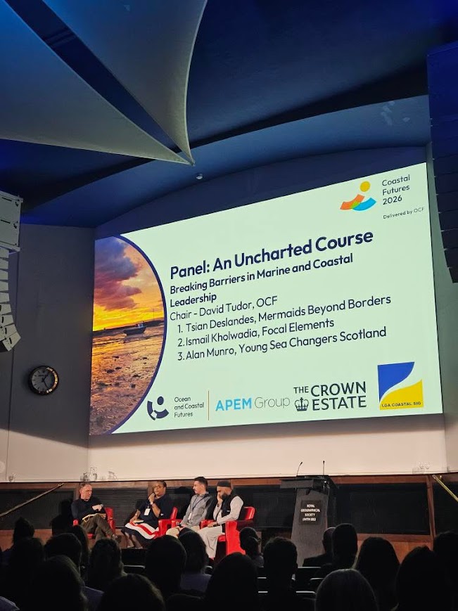 A projected panel slide listing Mermaids Beyond Borders among the speakers.